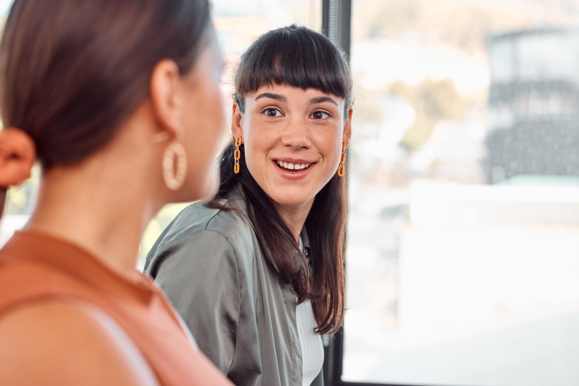 Colleagues having an engaged conversation in a bright office